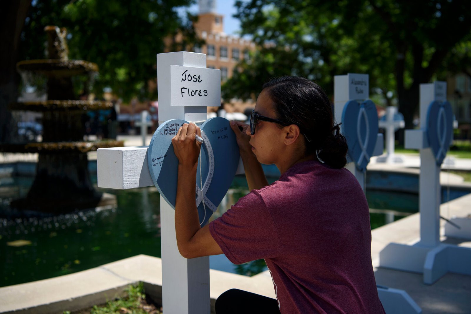 A mourner at one of many makeshift memorials around Uvalde.